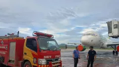 Terkena Abu Vulkanik Erupsi Gunung Ruang, Damkar Tomohan Bersihkan Landasan Pacu Bandara Sam Ratulangi - GenPI.co